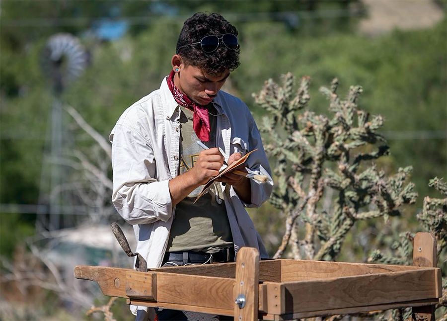 Field student Demitri DeLeon records information about artifacts recovered in the screen. (Photo by Tom Connelly)